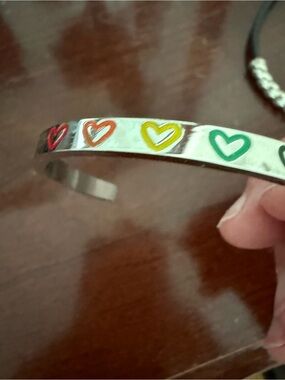 Silver cuff bracelet with engraved multi color hearts. Never worn